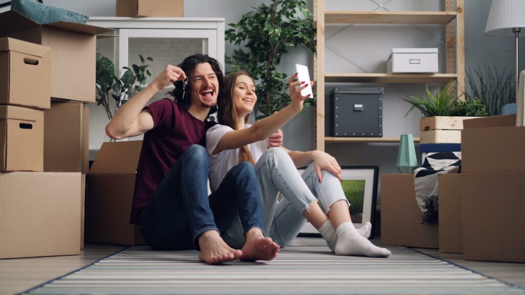 Pareja joven con las llaves de su primera vivienda en Andalucía